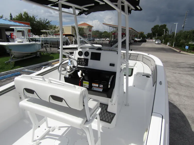Slide: The Image of 2024 Wellcraft 202 Fisherman boat with center console and seating, parked outdoors. - 27
