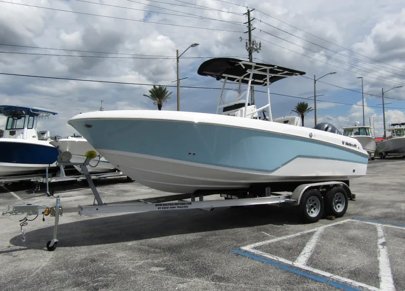 Slide: The Image of 2024 Wellcraft 202 Fisherman boat on trailer in parking lot. - 6
