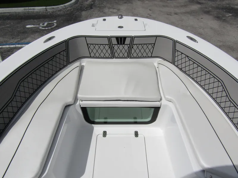 Slide: The Image of 2024 Wellcraft 202 Fisherman boat interior with cushioned seating and storage compartments. - 7