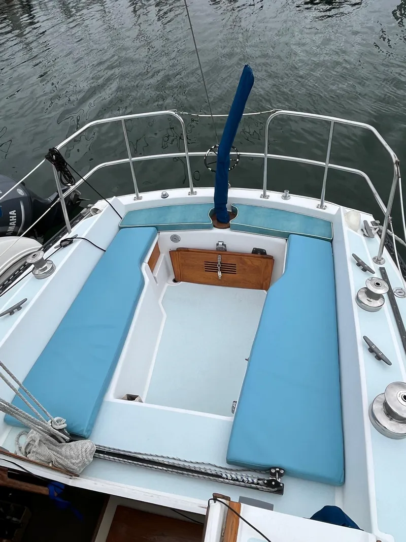 Slide: The Image of 1979 Ranger Yachts 30 sailboat with blue cushions on deck. - 11