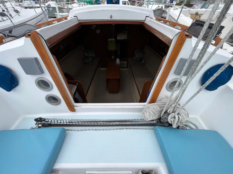 Slide: The Image of 1979 Ranger Yachts 30 sailboat interior view with seating and wooden accents. - 16