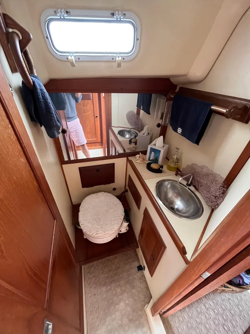 Slide: The Image of 1979 Ranger Yachts 30 bathroom with sink, mirror, and storage. - 33
