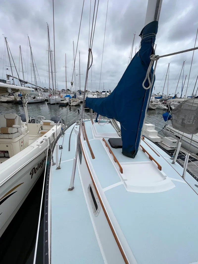 Slide: The Image of 1979 Ranger Yachts 30 sailboat docked in a marina with other boats. - 4