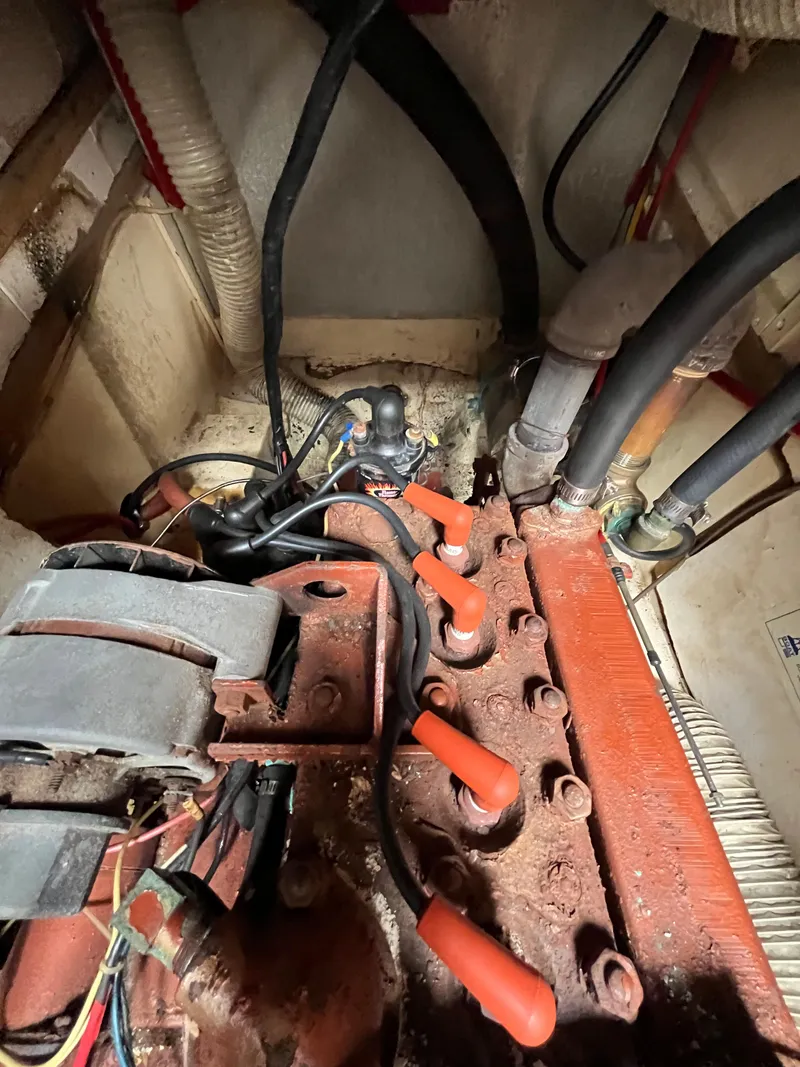 Slide: The Image of 1979 Ranger Yachts 30 engine compartment with visible wiring and hoses. - 41