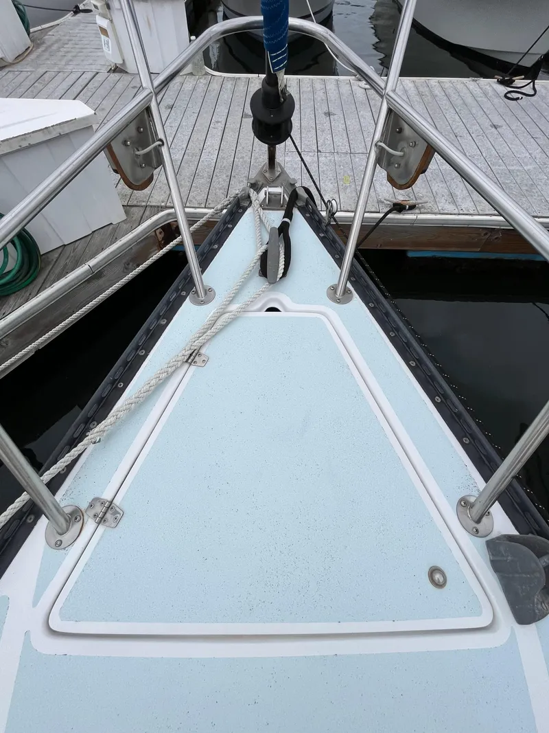 Slide: The Image of Bow of a 1979 Ranger Yachts 30 sailboat docked at a marina. - 5