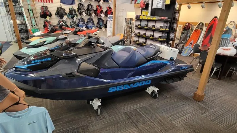 Slide: The Image of 2024 Sea-Doo GTX™ Limited 300 Blue Abyss on display in a showroom. - 1