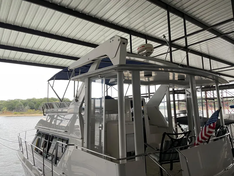 Slide: The Image of 1996 Carver 370 Aft Cabin yacht docked under a covered marina. - 10