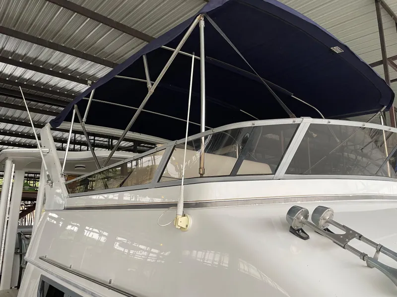 Slide: The Image of 1996 Carver 370 Aft Cabin yacht with blue canopy in covered dock. - 12