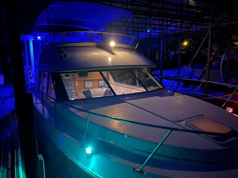 Slide: The Image of 1996 Carver 370 Aft Cabin yacht illuminated at night in marina. - 16