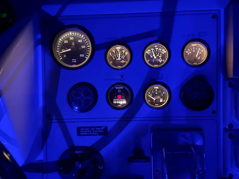 Slide: The Image of Dashboard of a 1996 Carver 370 Aft Cabin boat, illuminated in blue light. - 18