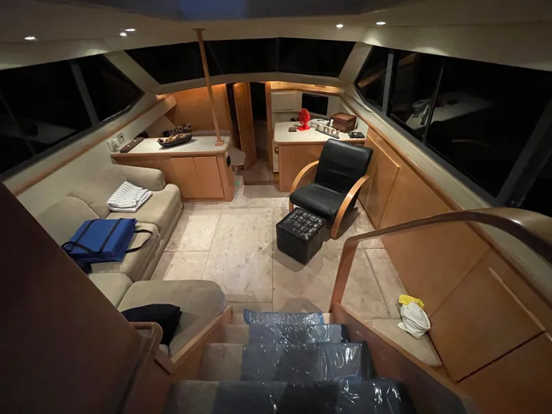 Slide: The Image of Interior of 1996 Carver 370 Aft Cabin yacht, featuring cozy seating and modern amenities. - 26