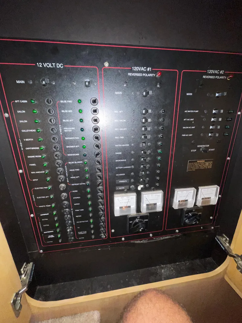 Slide: The Image of Electrical panel of a 1996 Carver 370 Aft Cabin boat, showing various switches and controls. - 27