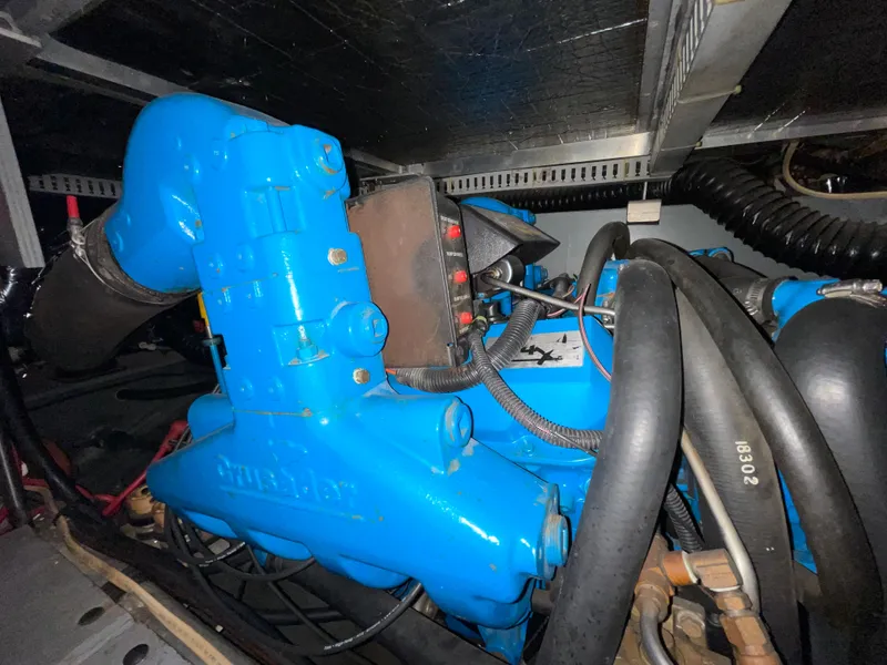 Slide: The Image of Engine compartment of a 1996 Carver 370 Aft Cabin boat, featuring blue engine components. - 3