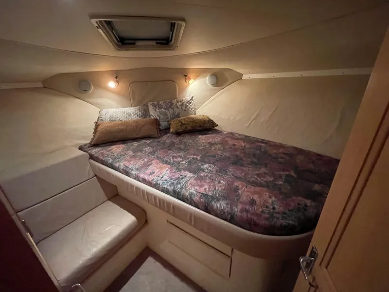 Slide: The Image of Cozy bedroom in 1996 Carver 370 Aft Cabin yacht with plush bedding and ambient lighting. - 32