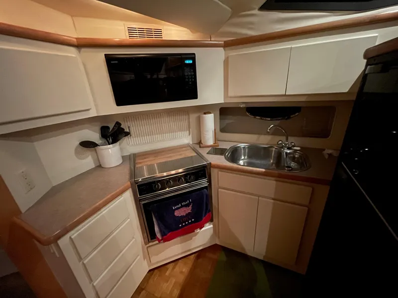 Slide: The Image of Compact kitchen in 1996 Carver 370 Aft Cabin yacht with stove, sink, and microwave. - 34