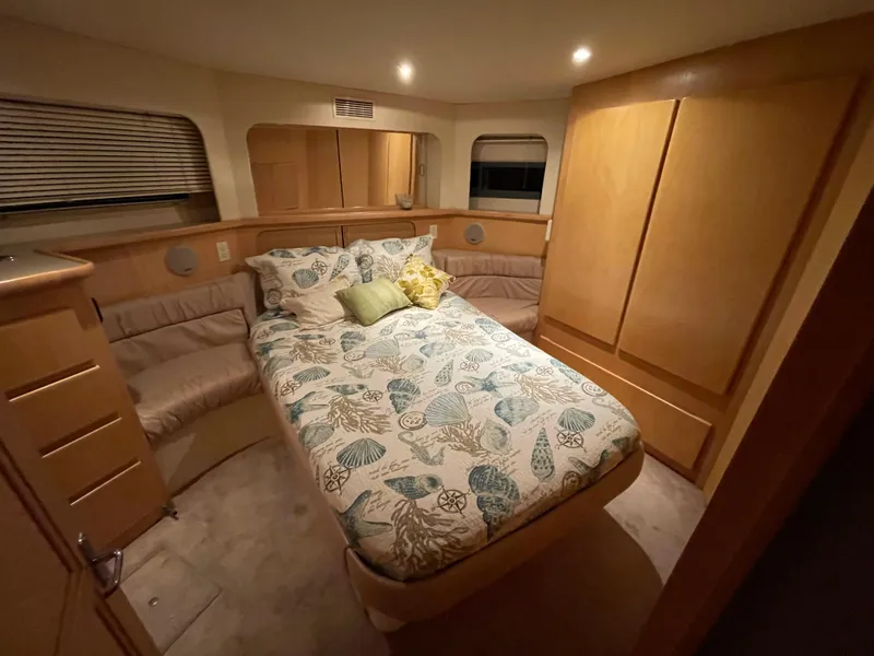 Slide: The Image of Cozy bedroom in 1996 Carver 370 Aft Cabin yacht with elegant wood finishes. - 35