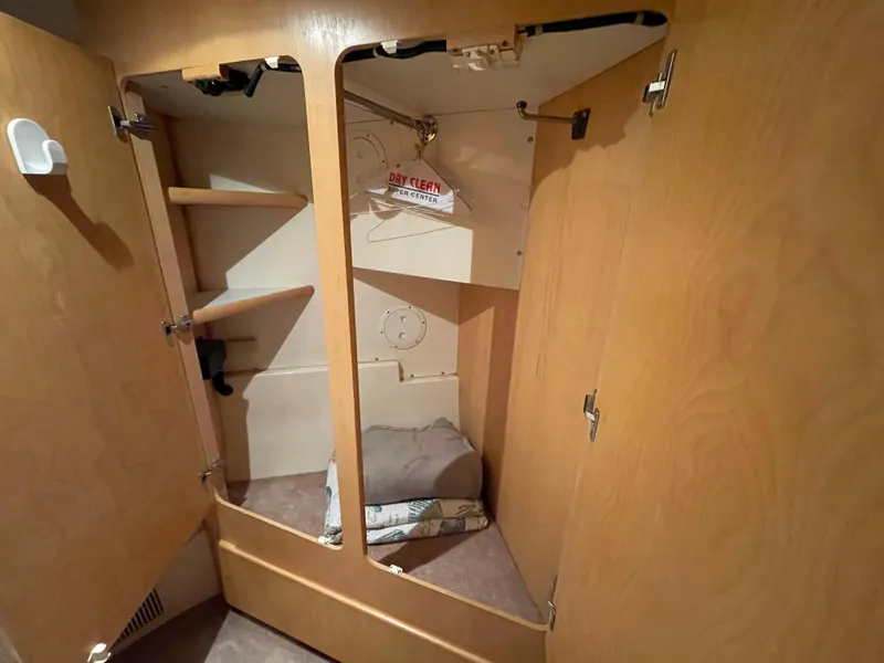 Slide: The Image of Interior closet of 1996 Carver 370 Aft Cabin with wooden shelves and hangers. - 36