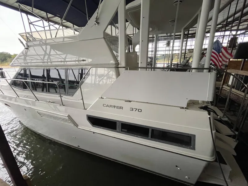 Slide: The Image of 1996 Carver 370 Aft Cabin yacht docked in marina, side view. - 6
