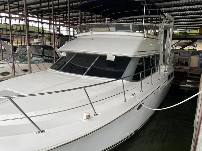 Slide: The Image of 1996 Carver 370 Aft Cabin yacht docked in a covered marina. - 9