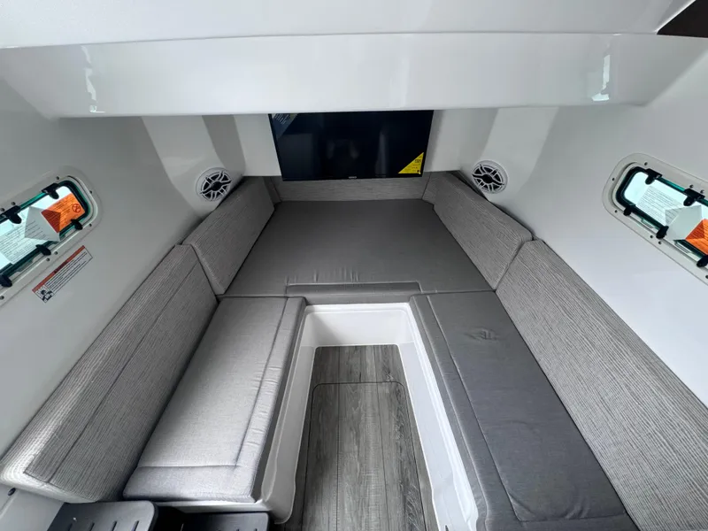 Slide: The Image of 2024 Everglades 395 CC cabin interior with gray seating and modern design. - 16
