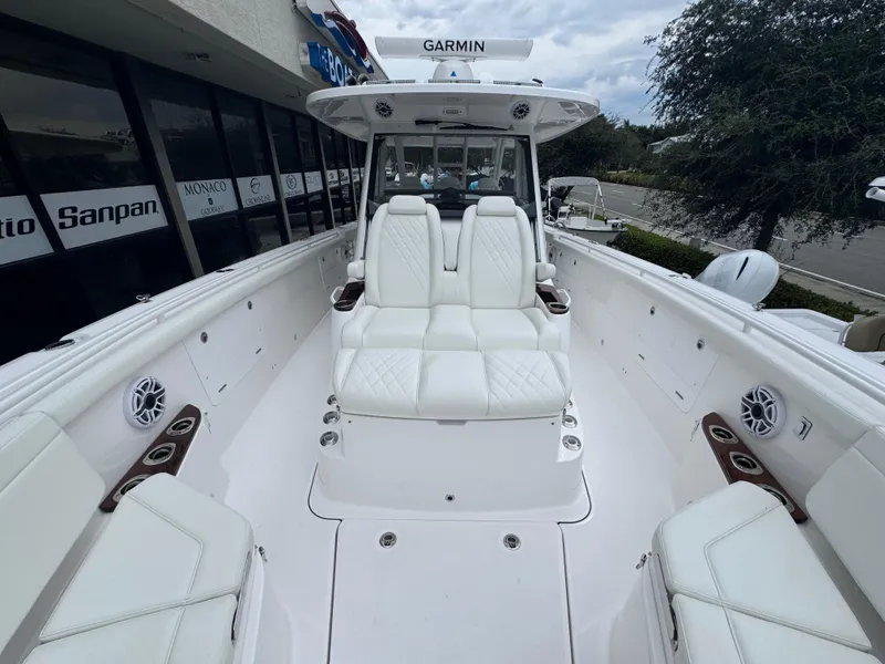 Slide: The Image of 2024 Everglades 395 CC boat interior with white seating and Garmin equipment. - 22