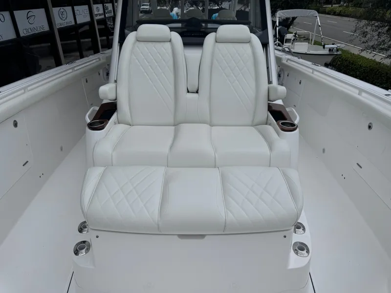 Slide: The Image of 2024 Everglades 395 CC boat with luxurious white seating and cup holders. - 23