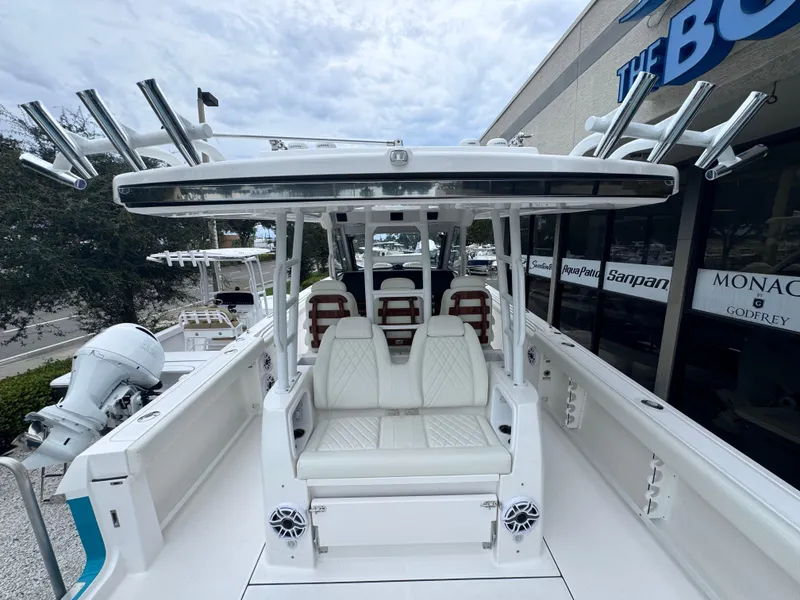 Slide: The Image of 2024 Everglades 395 CC boat with white seating and fishing rod holders. - 25