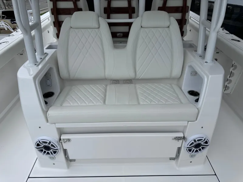 Slide: The Image of 2024 Everglades 395 CC boat interior with white leather seating and built-in speakers. - 28