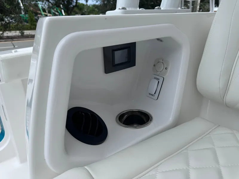 Slide: The Image of 2024 Everglades 395 CC boat interior with control panel and cup holder. - 29