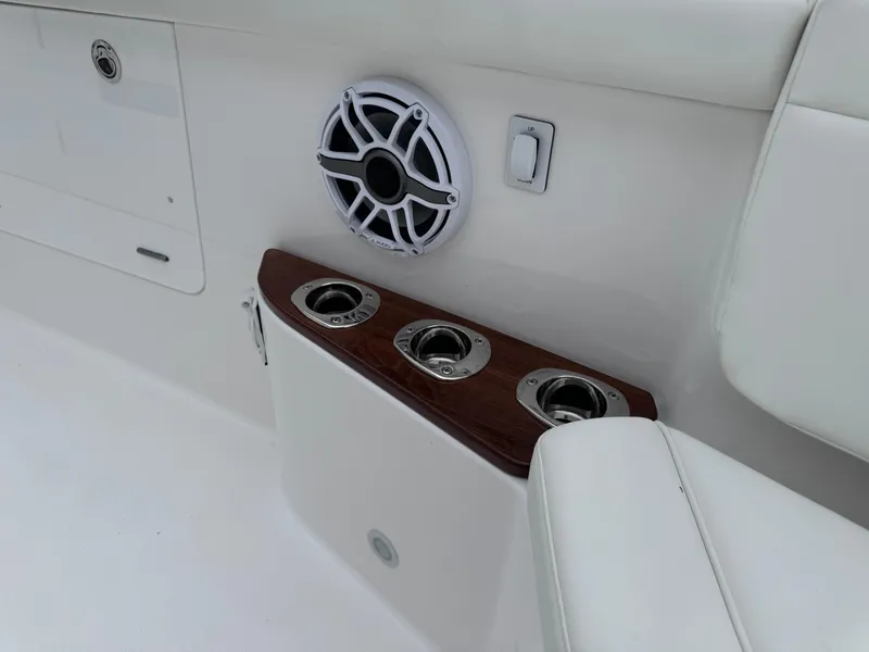 Slide: The Image of 2024 Everglades 395 CC boat interior with cup holders and speaker. - 31