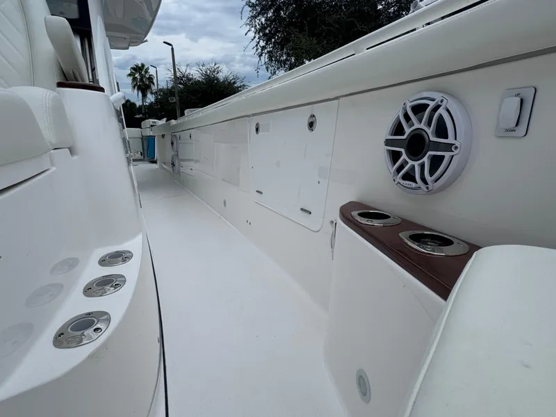 Slide: The Image of 2024 Everglades 395 CC boat interior with speakers and cup holders. - 32
