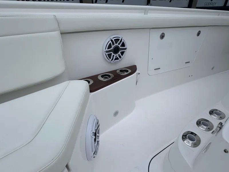 Slide: The Image of 2024 Everglades 395 CC boat interior with cup holders and speaker. - 34