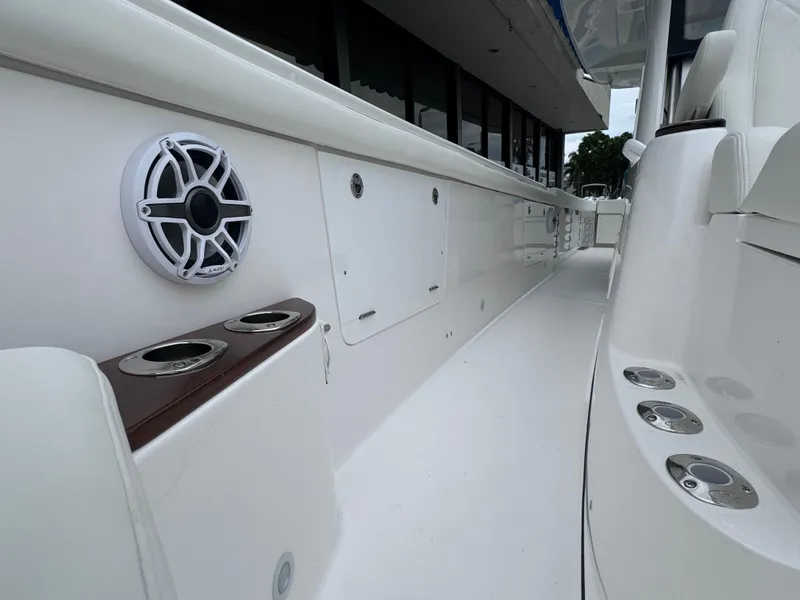 Slide: The Image of 2024 Everglades 395 CC boat interior with cup holders and speaker. - 35