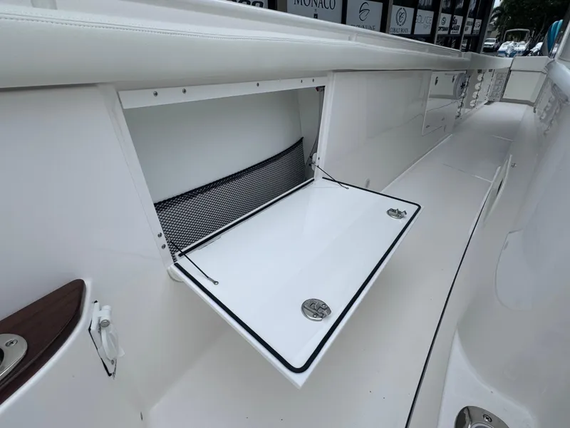 Slide: The Image of 2024 Everglades 395 CC boat storage compartment with open hatch. - 36