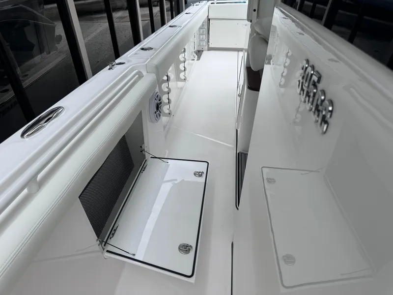 Slide: The Image of 2024 Everglades 395 CC boat interior with open storage compartment. - 38