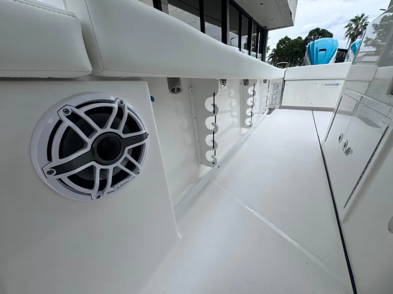 Slide: The Image of 2024 Everglades 395 CC boat interior with speaker and storage compartments. - 39
