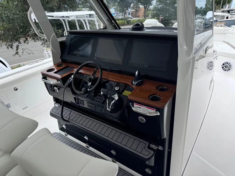Slide: The Image of 2024 Everglades 395 CC boat helm with modern controls and displays. - 42
