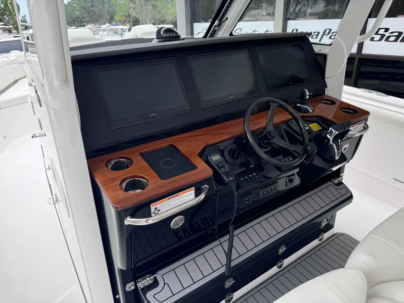 Slide: The Image of 2024 Everglades 395 CC boat dashboard with modern controls and sleek design. - 43