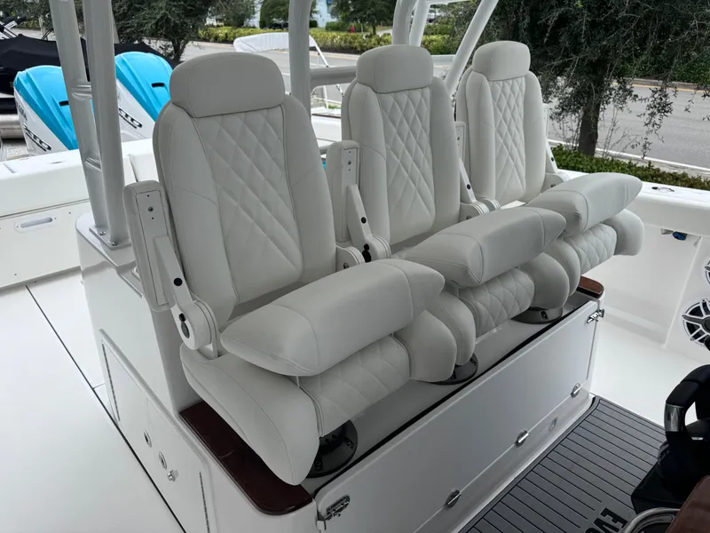 Slide: The Image of Luxurious white seating on 2024 Everglades 395 CC boat, featuring diamond stitching and armrests. - 44