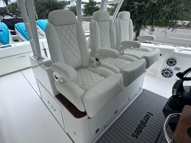 Slide: The Image of Luxurious seating on 2024 Everglades 395 CC boat with white quilted upholstery. - 45