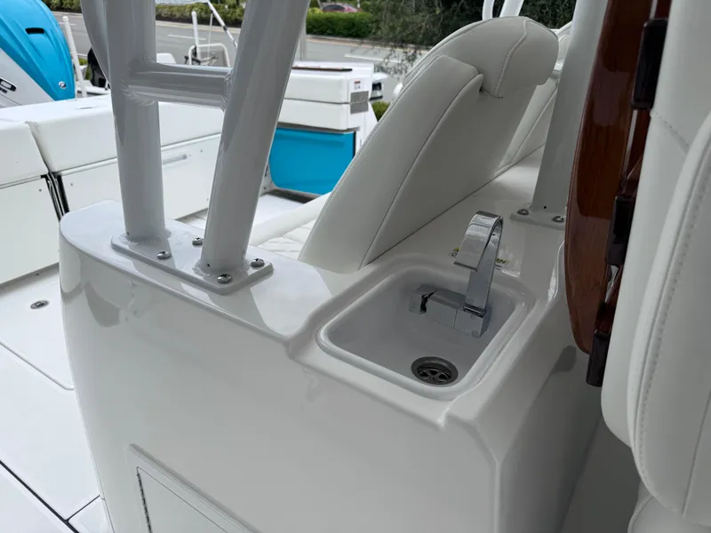 Slide: The Image of 2024 Everglades 395 CC boat interior with sleek white seating and modern fixtures. - 46