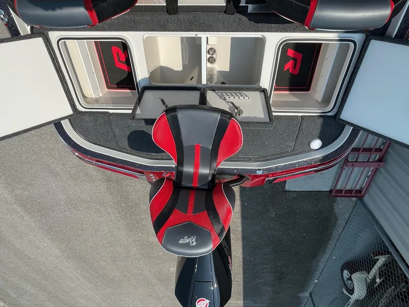 Slide: The Image of 2024 Ranger Z520R boat interior with red and black seating and storage compartments. - 11