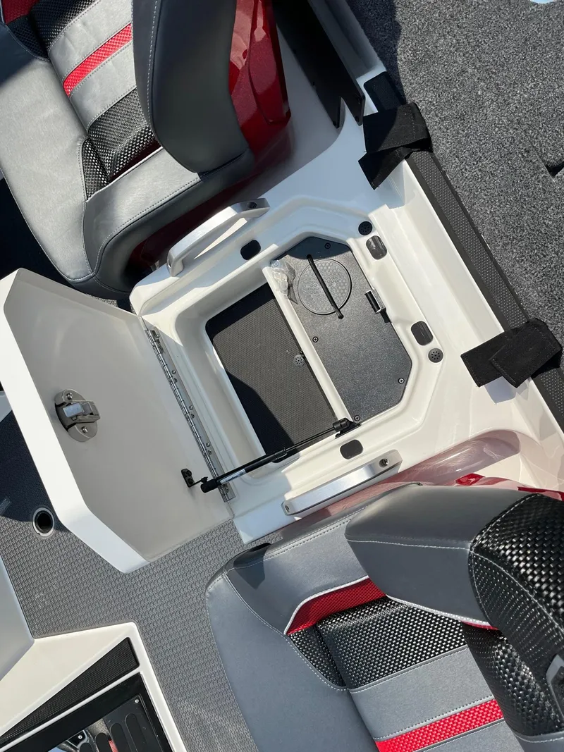 Slide: The Image of 2024 Ranger Z520R boat interior storage compartment with open lid and seating. - 12