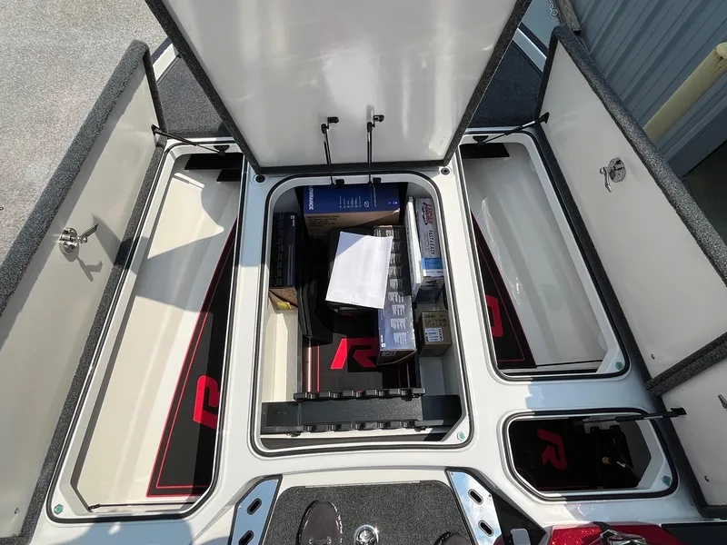 Slide: The Image of 2024 Ranger Z520R boat storage compartments with open lids and organized gear. - 6