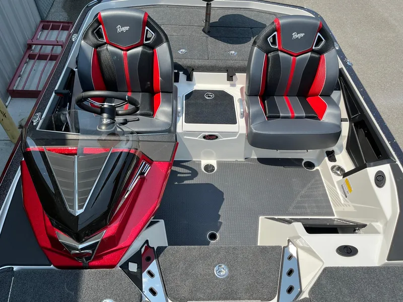 Slide: The Image of 2024 Ranger Z520R boat interior with black and red seats and steering console. - 9