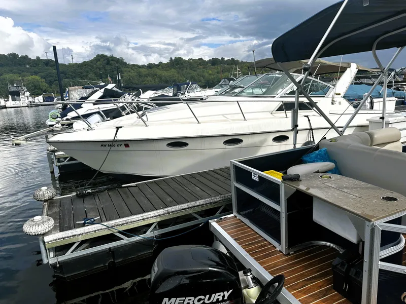 The Image of 1989 Tiara Yachts 310 SC docked at a marina with other boats. - 1