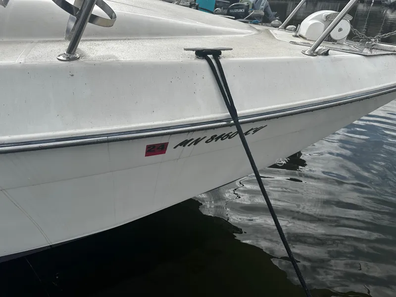 Slide: The Image of 1989 Tiara Yachts 310 SC docked, close-up of the bow with registration number. - 8