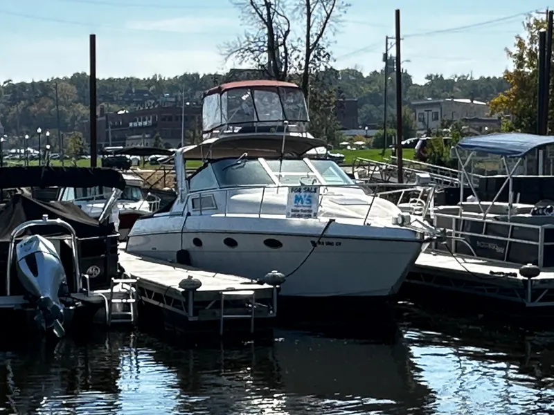Slide: The Image of 1989 Tiara Yachts 310 SC docked at a marina, for sale sign visible. - 9