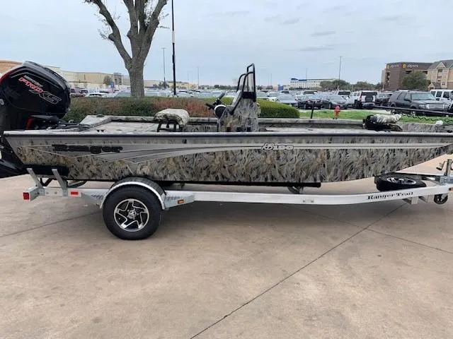 The Image of 2024 Ranger RB190 boat on trailer, camo design, parked outdoors. - 0