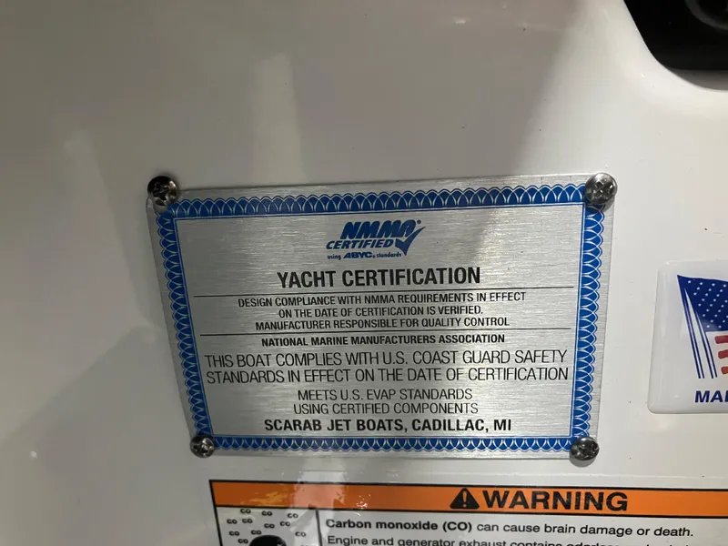 Slide: The Image of 2024 Scarab 285 yacht certification plaque, NMMA certified, U.S. Coast Guard safety standards compliance. - 12
